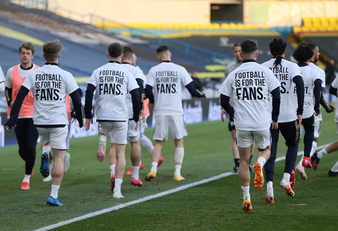 Leeds United players during the warm up before the match wearing UEFA Champions League T- Shirts with messages saying Football is for the Fans