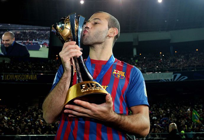 Mascherano kisses a trophy