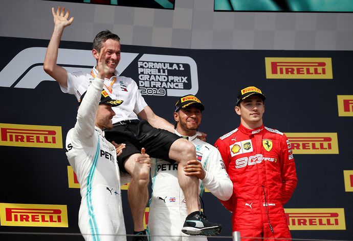 Mercedes' Lewis Hamilton celebrates on the podium after winning the race alongside second placed Mercedes' Valtteri Bottas and third placed Ferrari's Charles Leclerc
