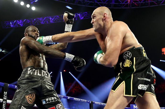 Tyson Fury throws a straight right hand at Deontay Wilder during their second fight.
