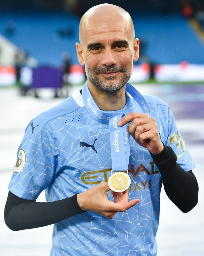 Guardiola with his PL winner medal