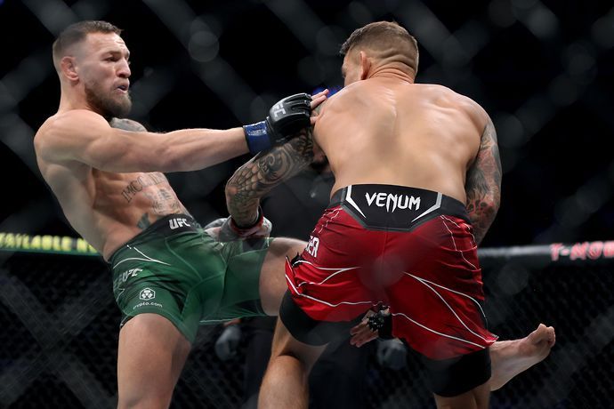 Dustin Poirier catches a kick from Conor McGregor