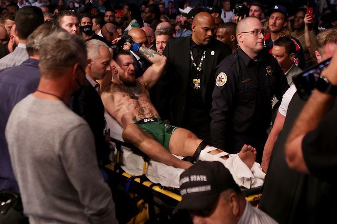 Conor McGregor is carried out of the Octagon on a stretcher