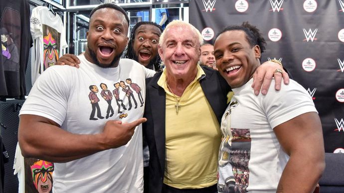 Ric Flair poses for a picture with New Day at a WWE event