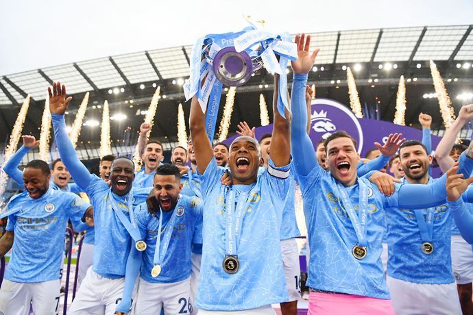 Man City players celebrate and lift the Premier League title