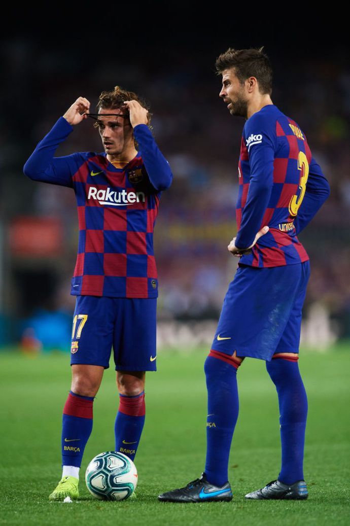 Antoine Griezmann and Gerard Pique in action for Barcelona