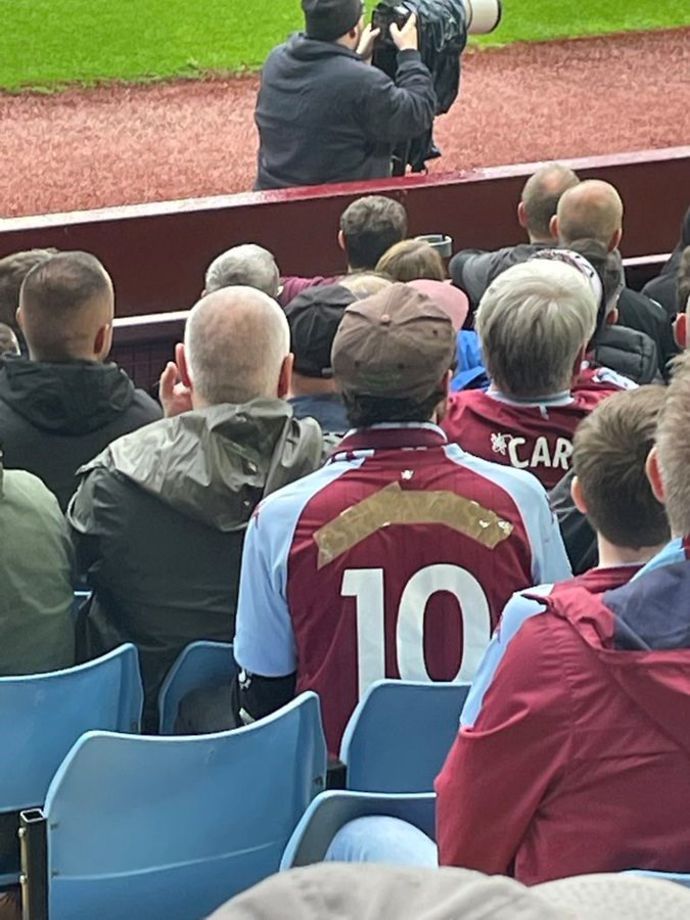 An Aston Villa fan was pictured wearing a home shirt with Jack Grealish's name taped up