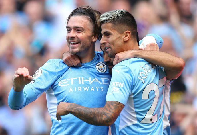 Jack Grealish and Joao Cancelo in action for Man City
