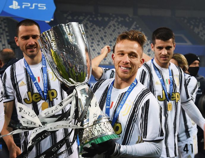 Arthur Melo celebrates lifting the Italian Supercoppa with Juventus