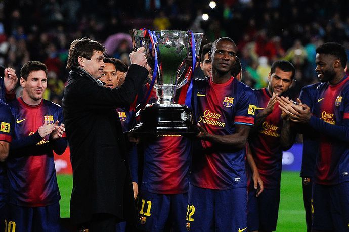 Eric Abidal and Tito Villanova lift the La Liga trophy in 2013