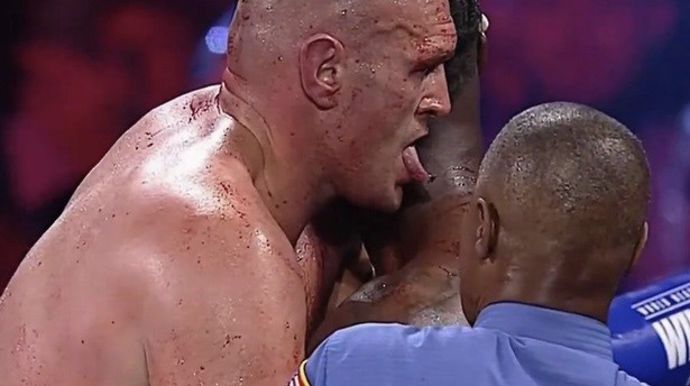 Tyson Fury licks Deontay Wilder's blood