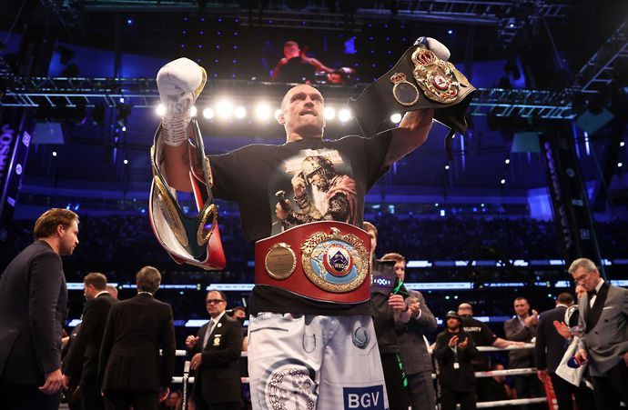 Usyk poses with his belts after beating Joshua