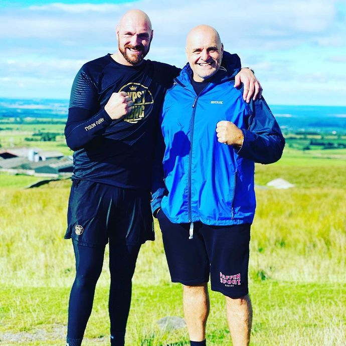 John (right) pictured with his son Tyson Fury