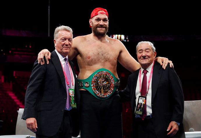 Tyson Fury celebrates with Frank Warren and Bob Arum after beating Deontay Wilder