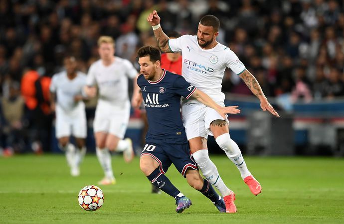 Lionel Messi battles for the ball with Kyle Walker