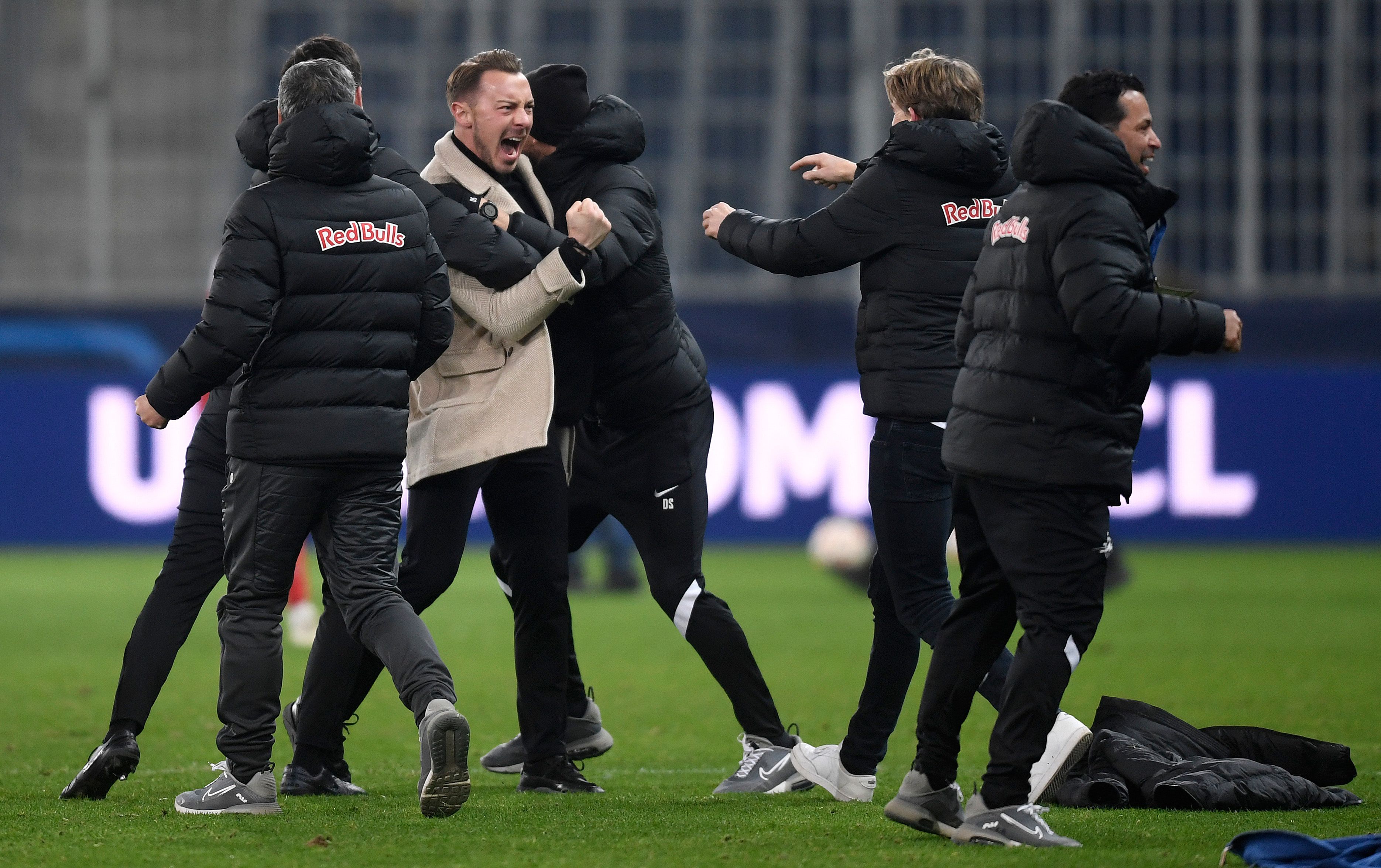 Matthias Jaissle, Head Coach of Red Bull Salzburg celebrates with the backroom staff after victory in the UEFA Champions League 