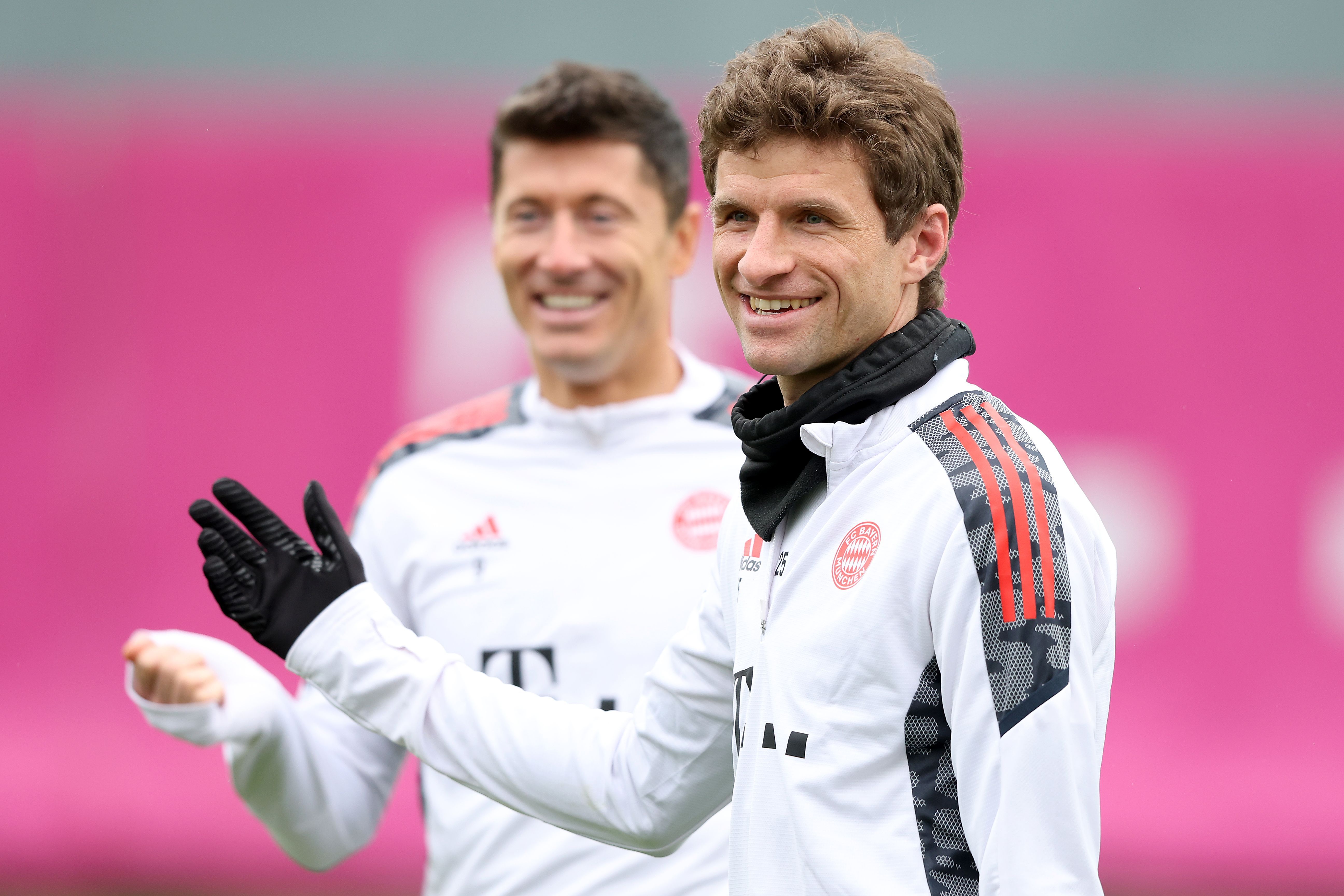 Thomas Müller of FC Bayern München smiles with team mate Robert Lewandowski 