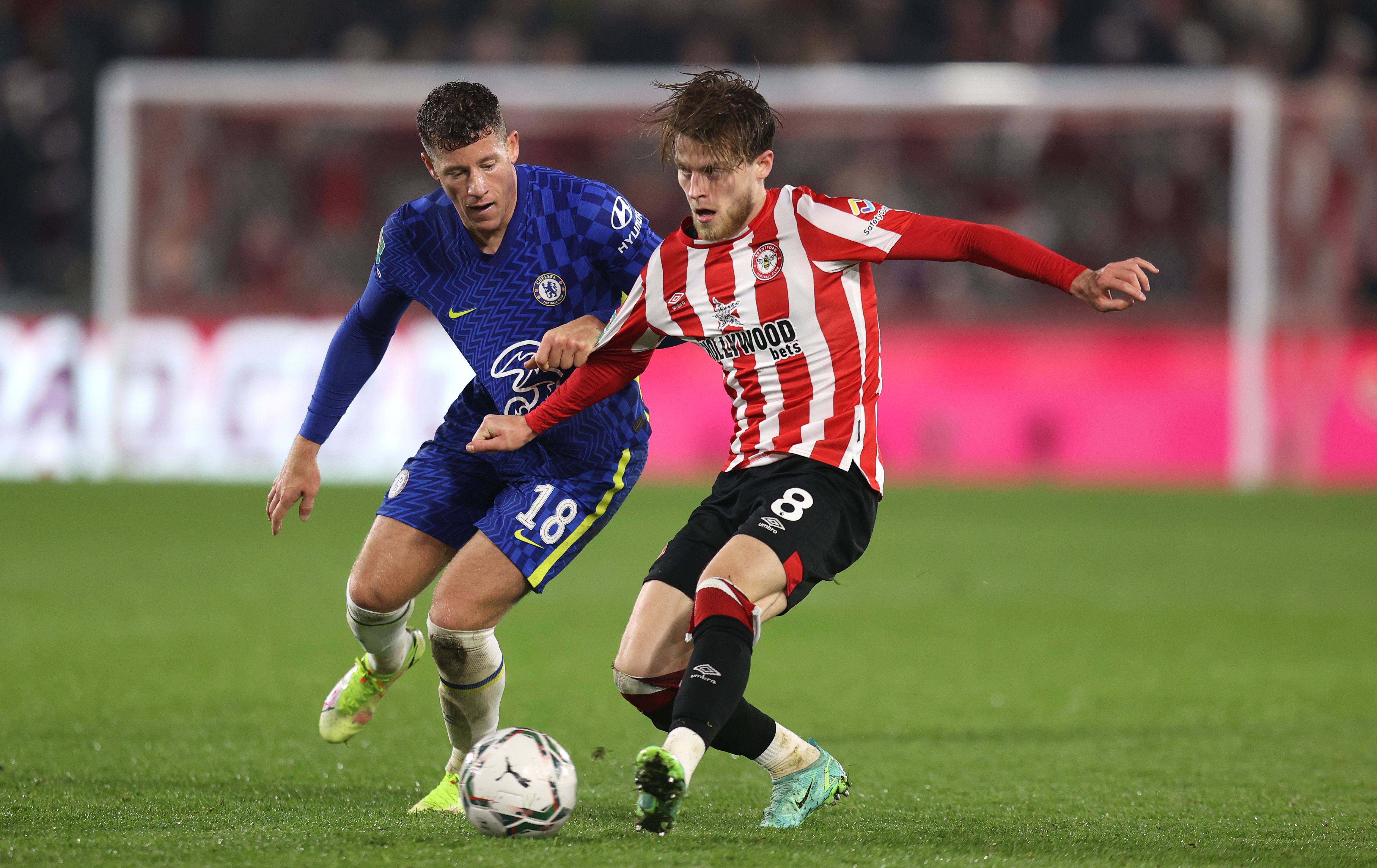 Mathias Jensen of Brentford is challenged by Ross Barkley of Chelsea during the Carabao Cup Quarter Final match between Brentford and Chelsea at Brentford Community Stadium 