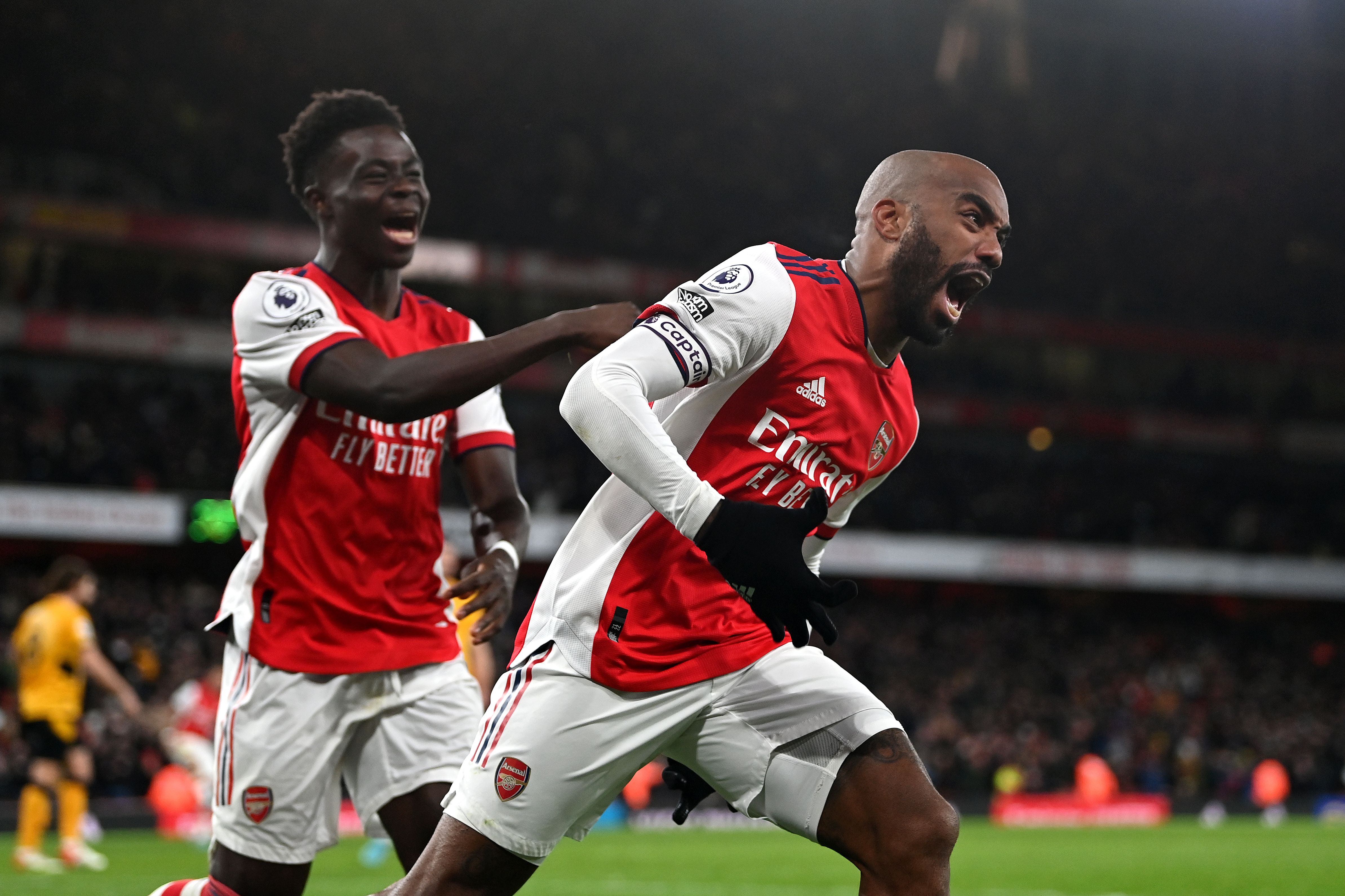 lexandre Lacazette of Arsenal celebrates their sides second goal with team mate Bukayo Saka during the Premier League match between Arsenal and Wolverhampton Wanderers at Emirates Stadium on February 24, 2022