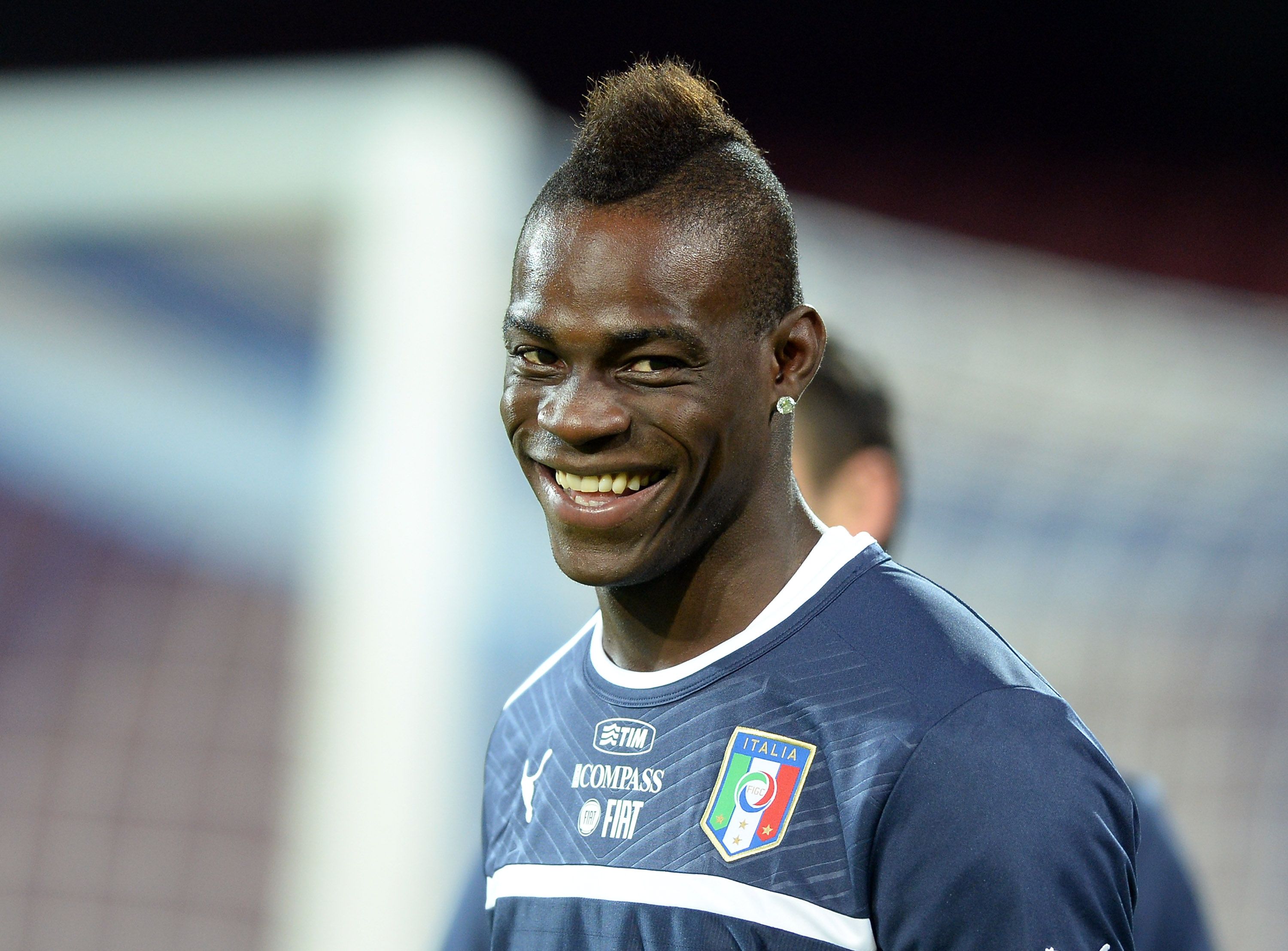 Mario Balotelli smiles during a training session for the Italian football national team