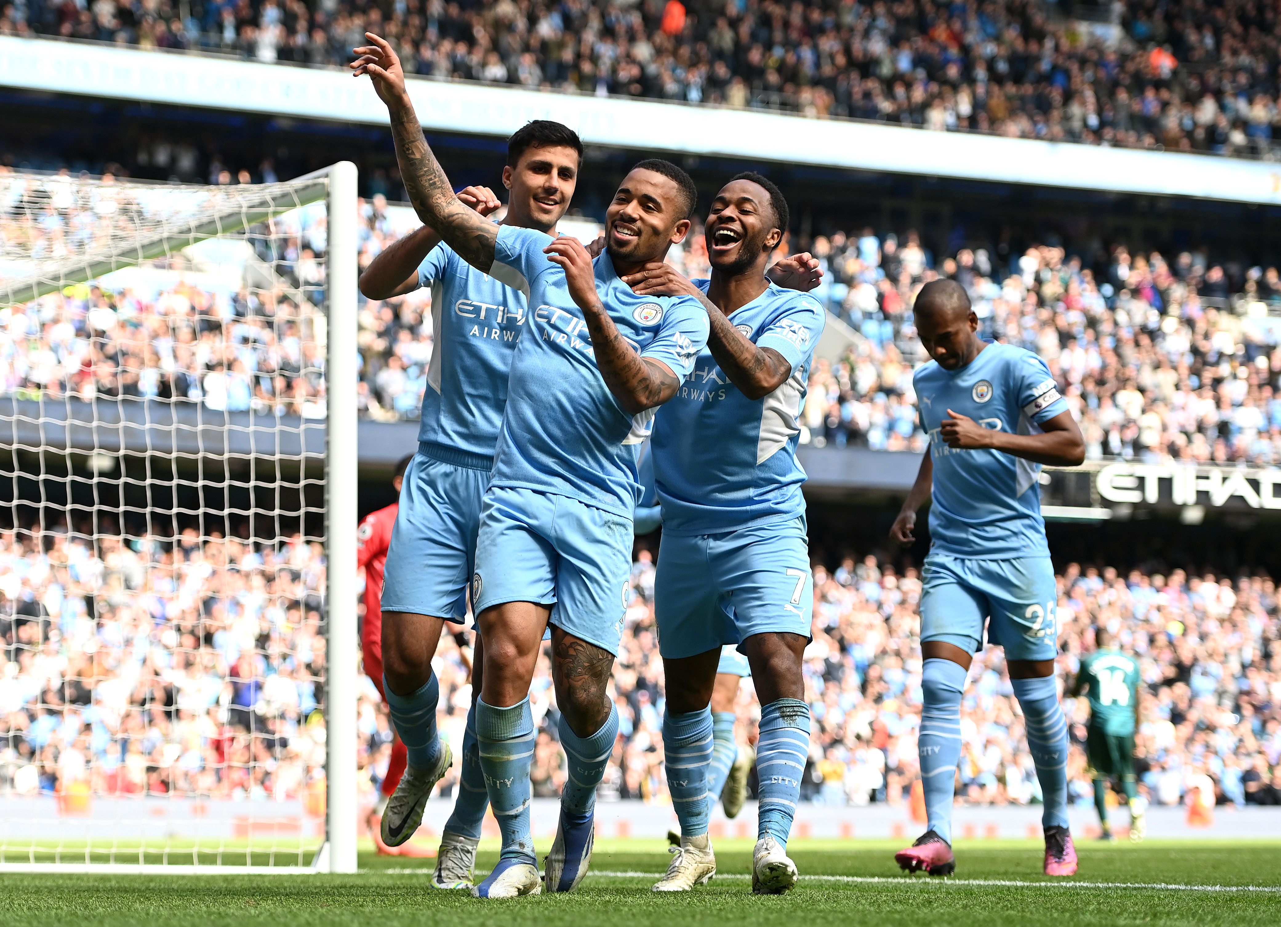 Gabriel Jesus celebrates with teammates Rodrigo and Raheem Sterling of Manchester City after scoring their side's fourth goal from a penalty during the Premier League match between Manchester City and Watford