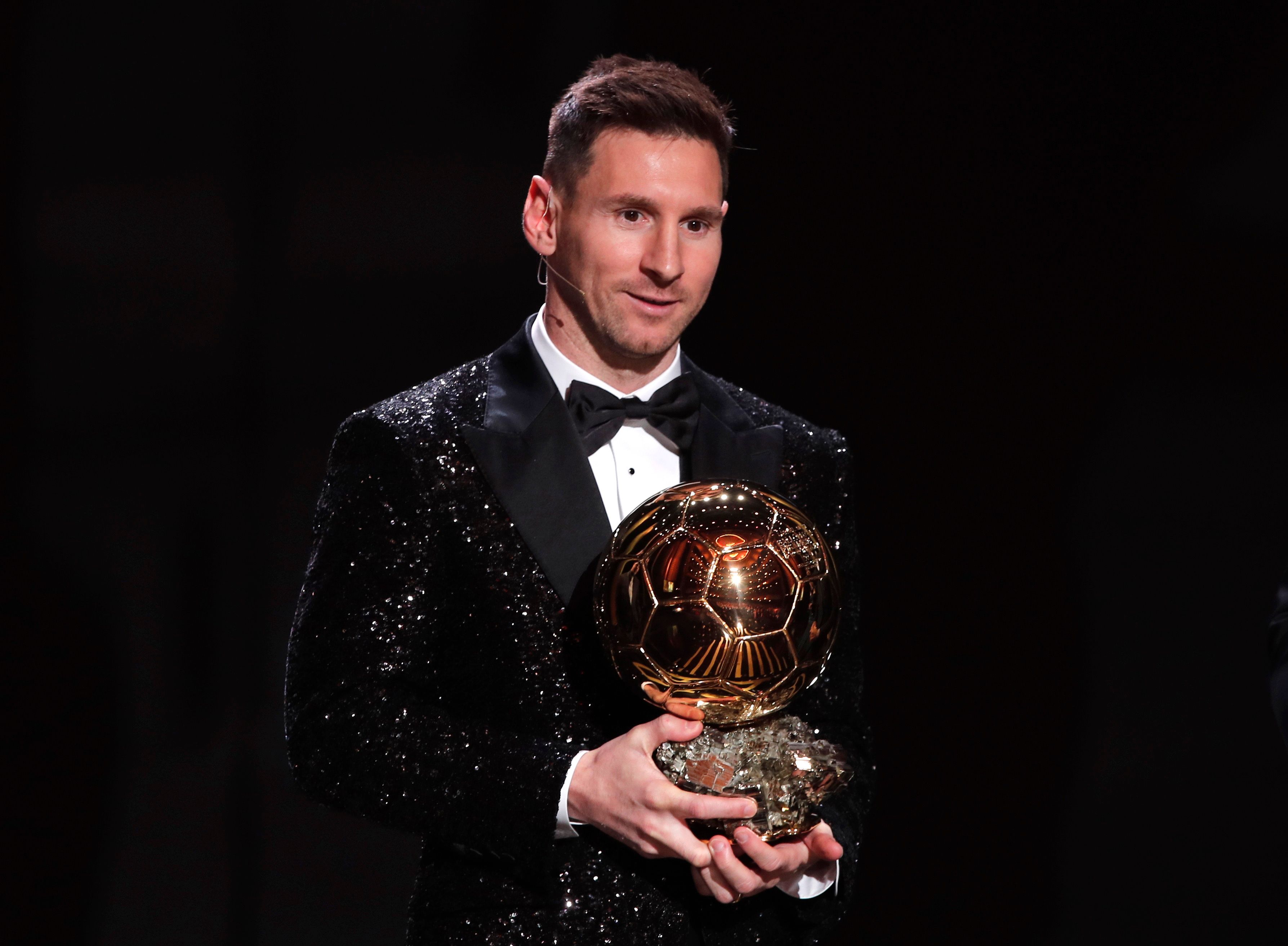 Lionel Messi poses with the Ballon d'Or