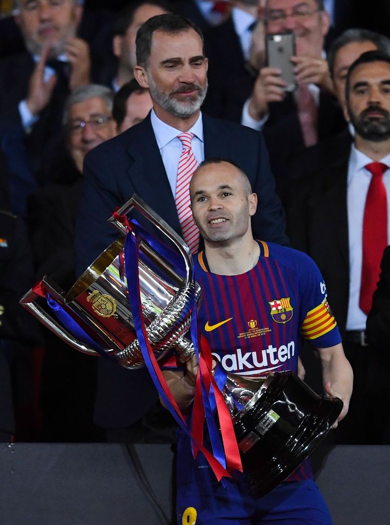 Andres Iniesta lifts a trophy with Barcelona
