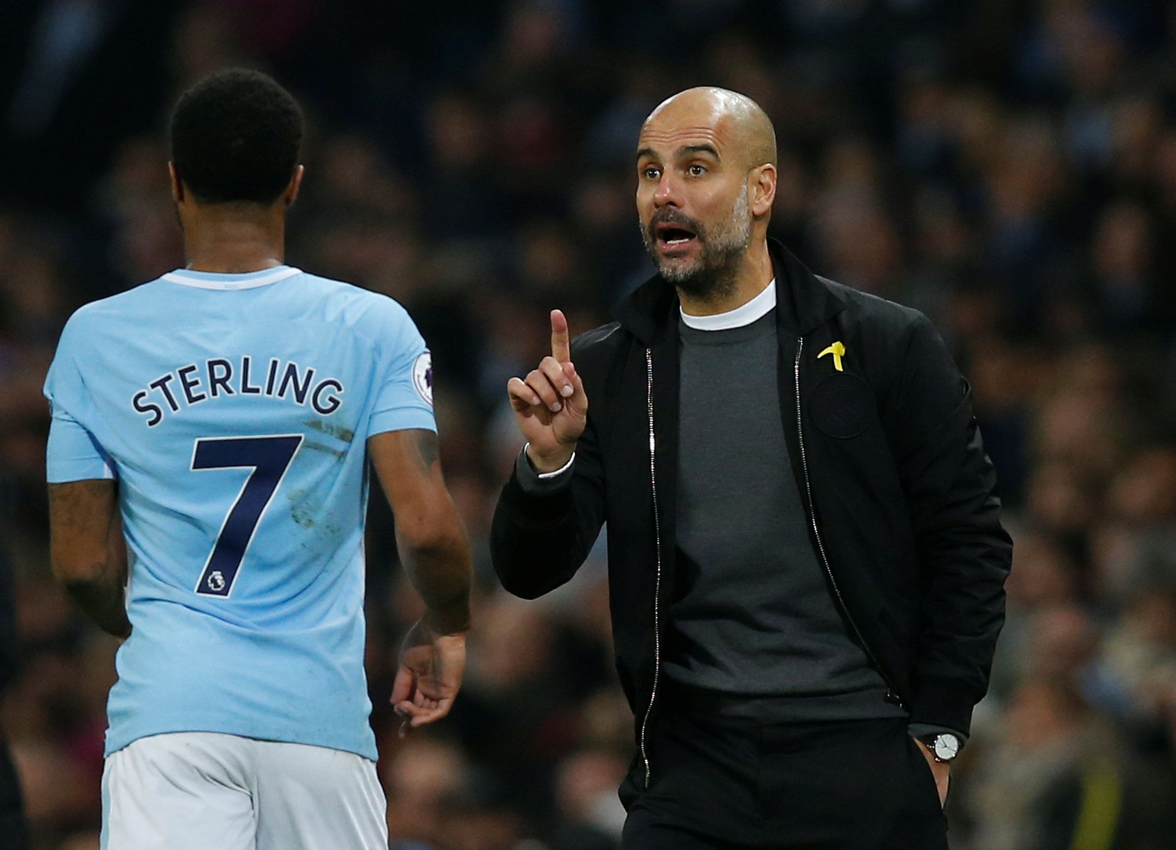 Guardiola talks to Sterling.