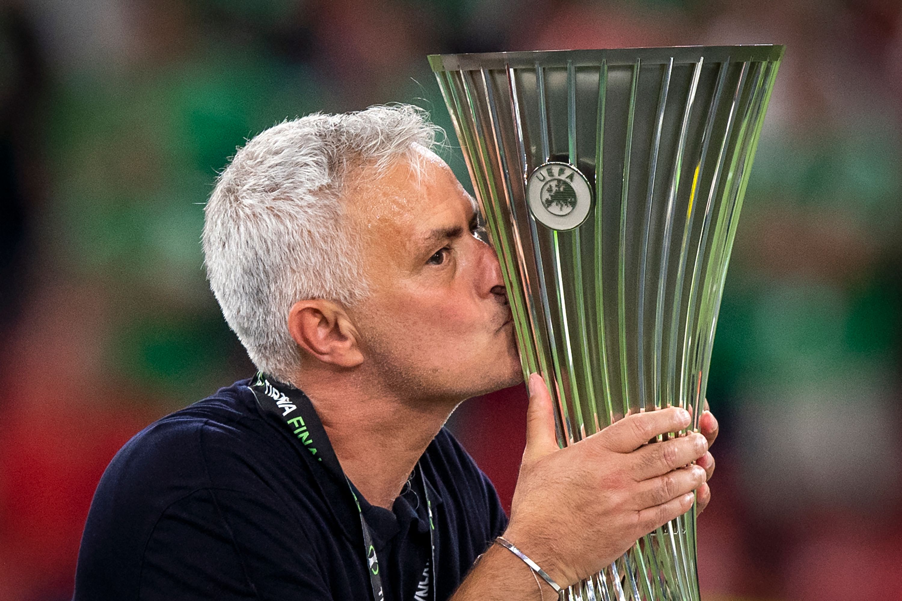 Jose Mourinho kisses the Europa Conference League trophy