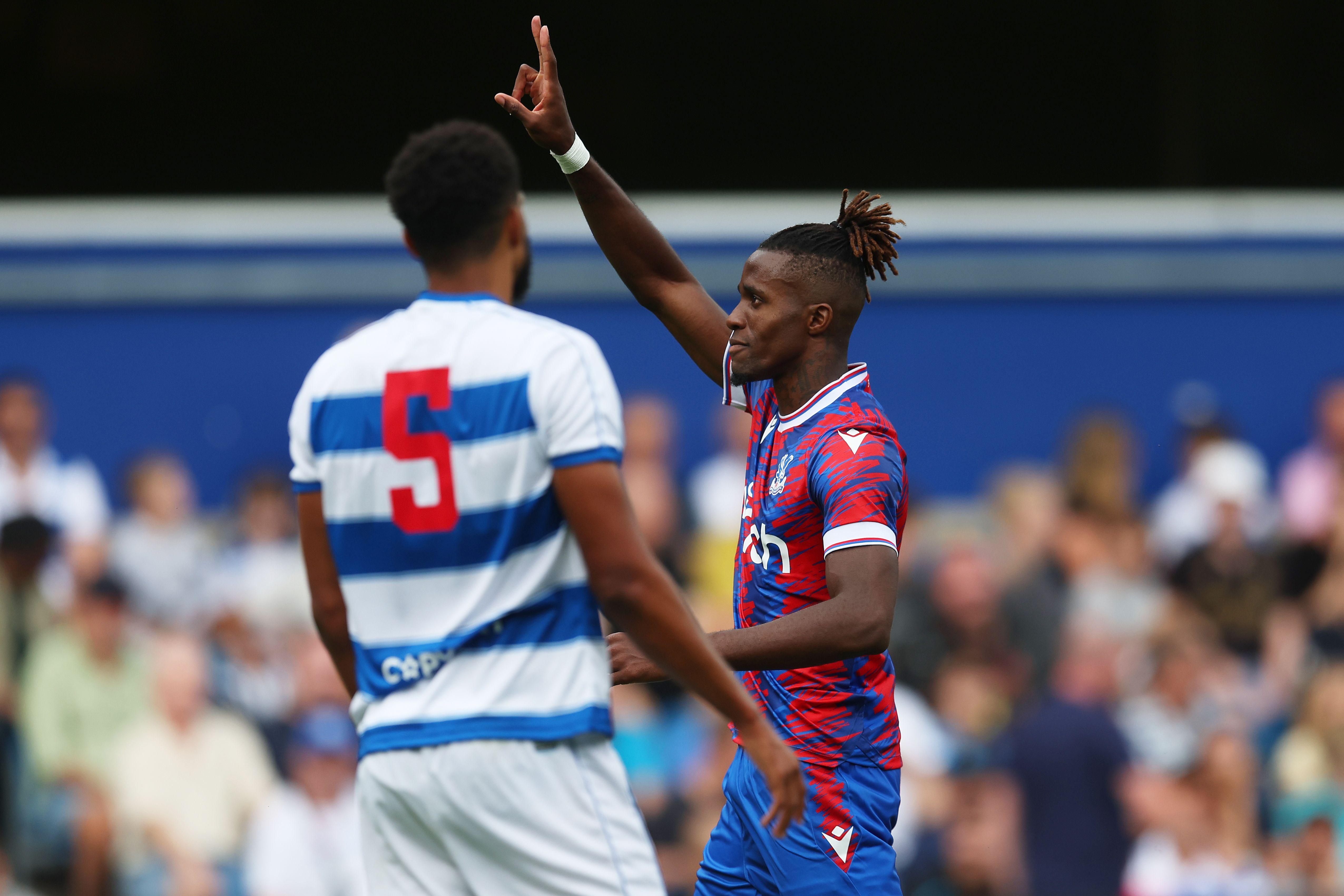 Wilfried Zaha of Crystal Palace celebrates after scoring their team's second goal during the Pre-Season Friendly Match between Queens Park Rangers and Crystal Palace at Loftus Road on July 23, 2022 in London, England.