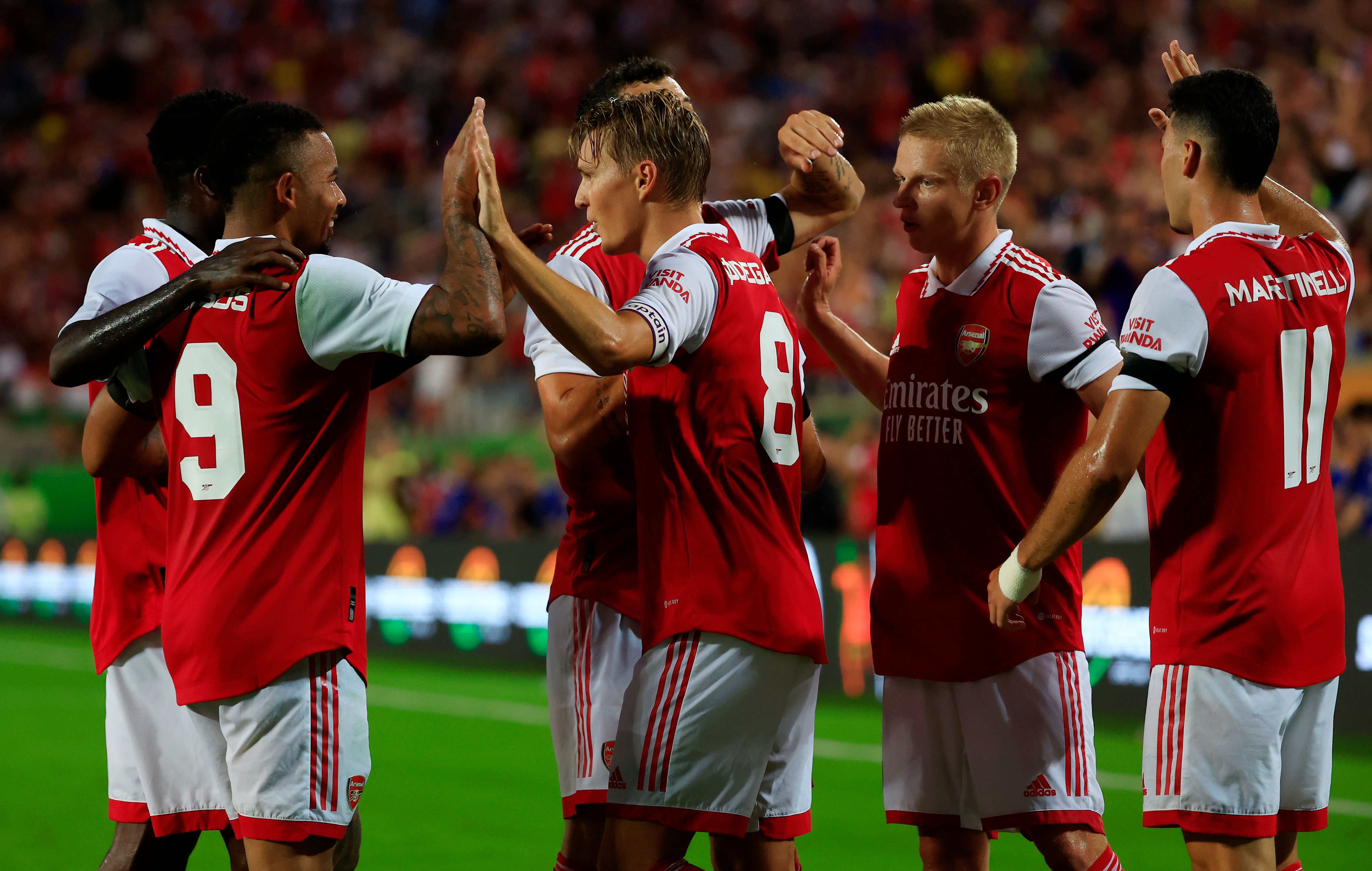 Martin Odegaard of Arsenal celebrates with teammates Gabriel Jesus and Oleksandr Zinchenko after scoring their side's second goal during the Florida Cup match between Chelsea and Arsenal at Camping World Stadium on July 23, 2022 in Orlando, Florida. 