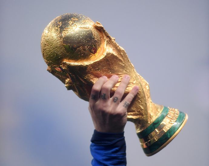 The World Cup trophy being held up 