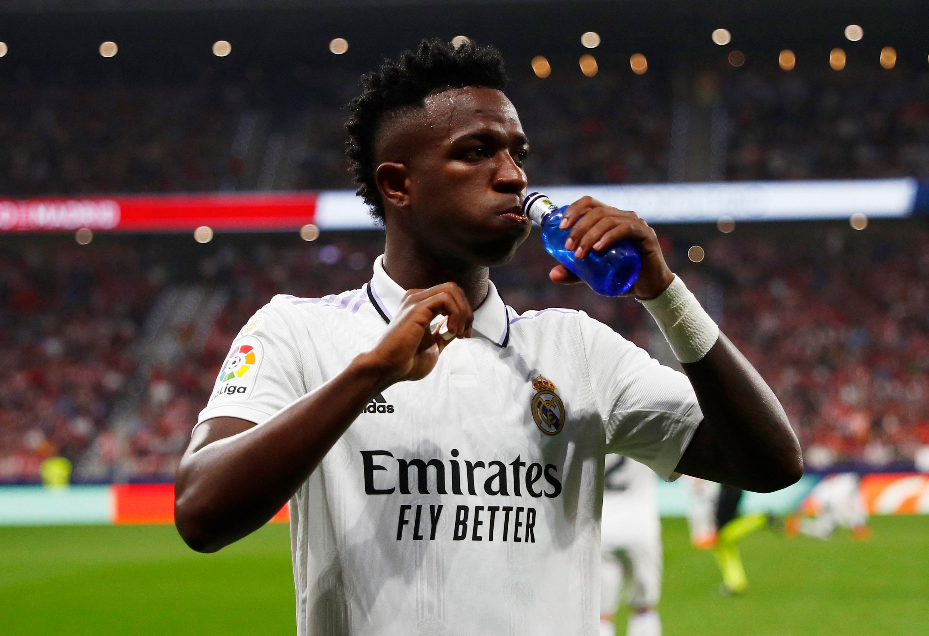 Real's Vinicius takes a drink.