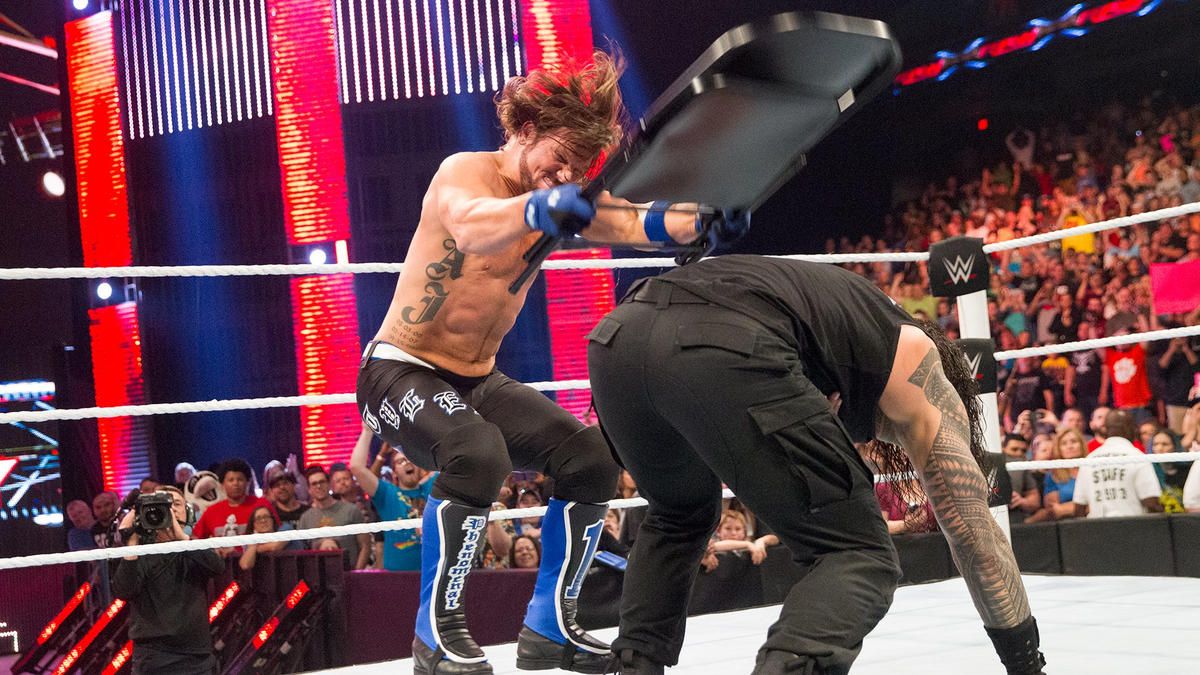 AJ Styles hitting Roman Reigns with a chair in WWE