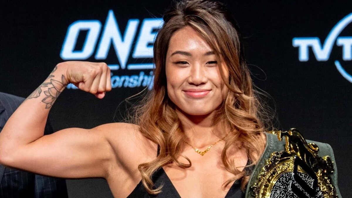 Angela Lee posing with her ONE FC title