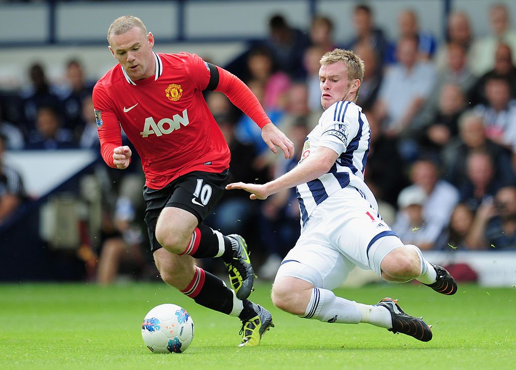 Wayne Rooney and Chris Brunt compete for the ball in West Brom vs Man Utd in 2011