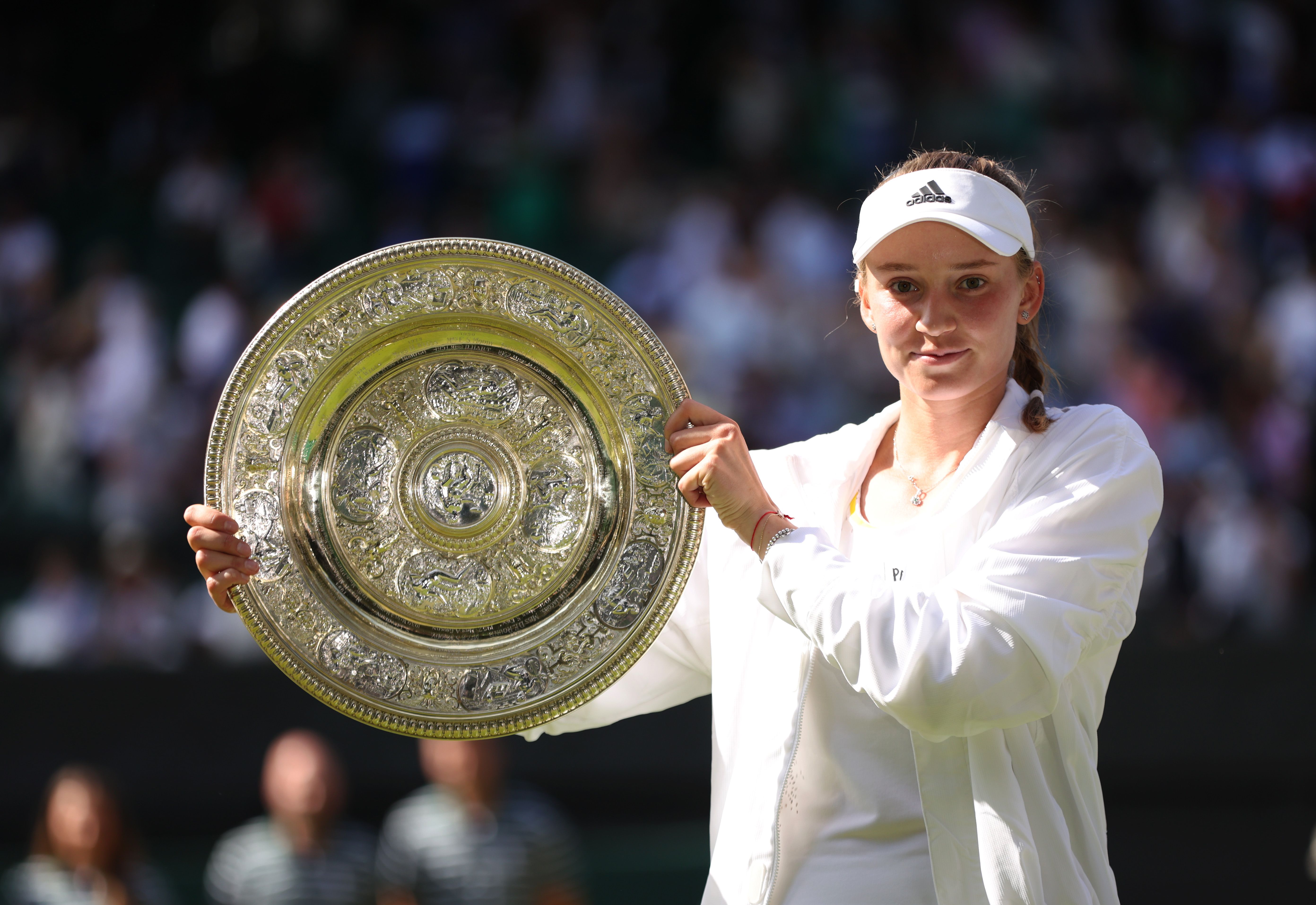 Elena Rybakina holds the Wimbledon trophy.