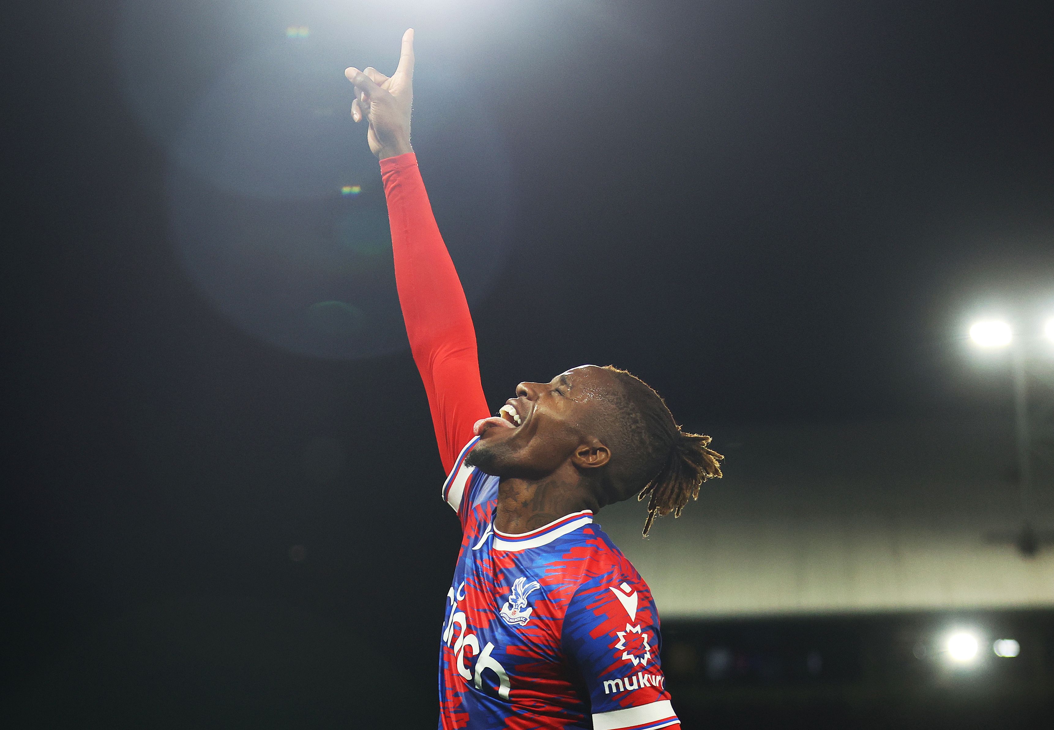 Wilfried Zaha of Crystal Palace celebrates after scoring their team's first goal during the Premier League match between Crystal Palace and Brentford FC at Selhurst Park on August 30, 2022 in London, England.