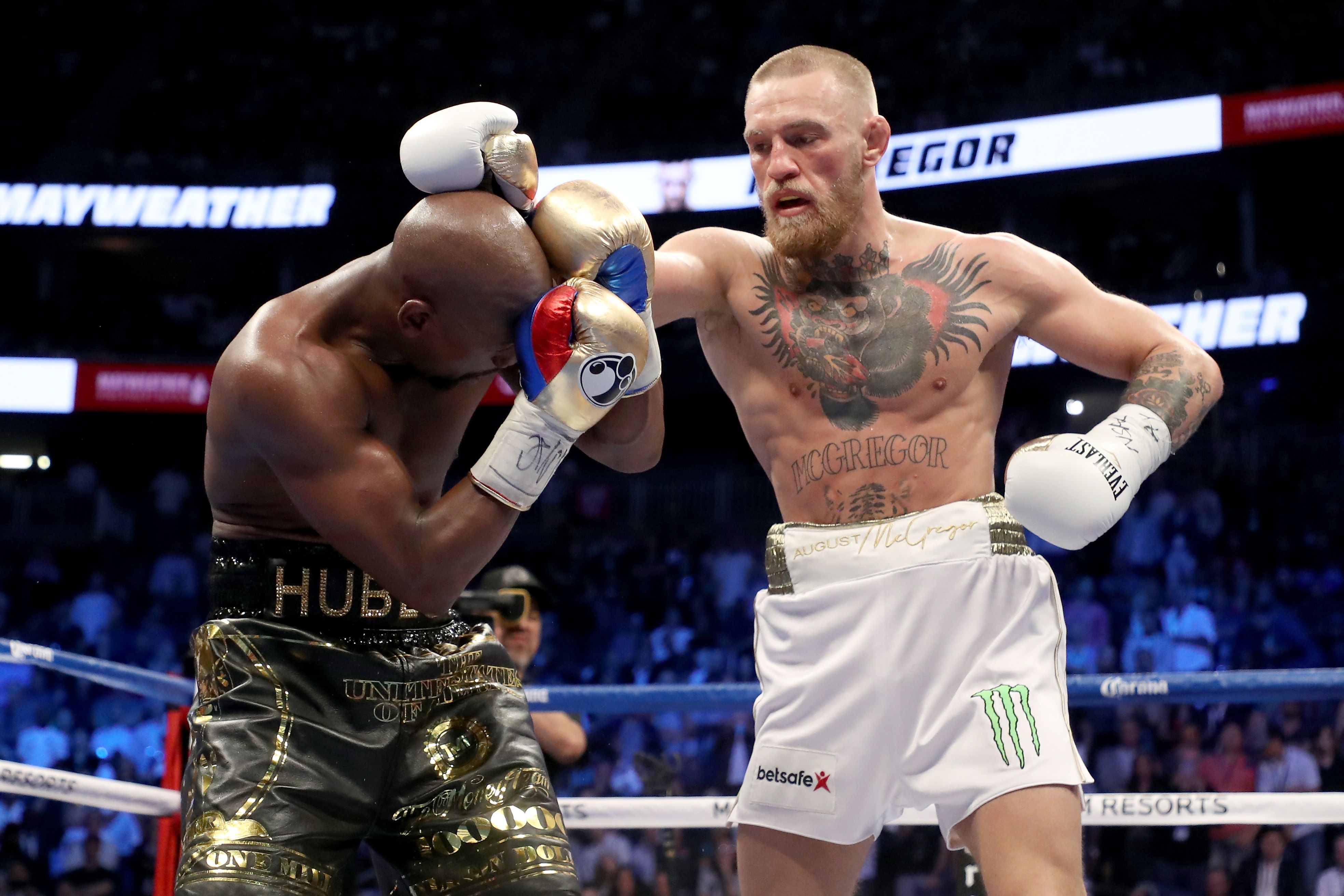 Conor McGregor throws a punch at Floyd Mayweather