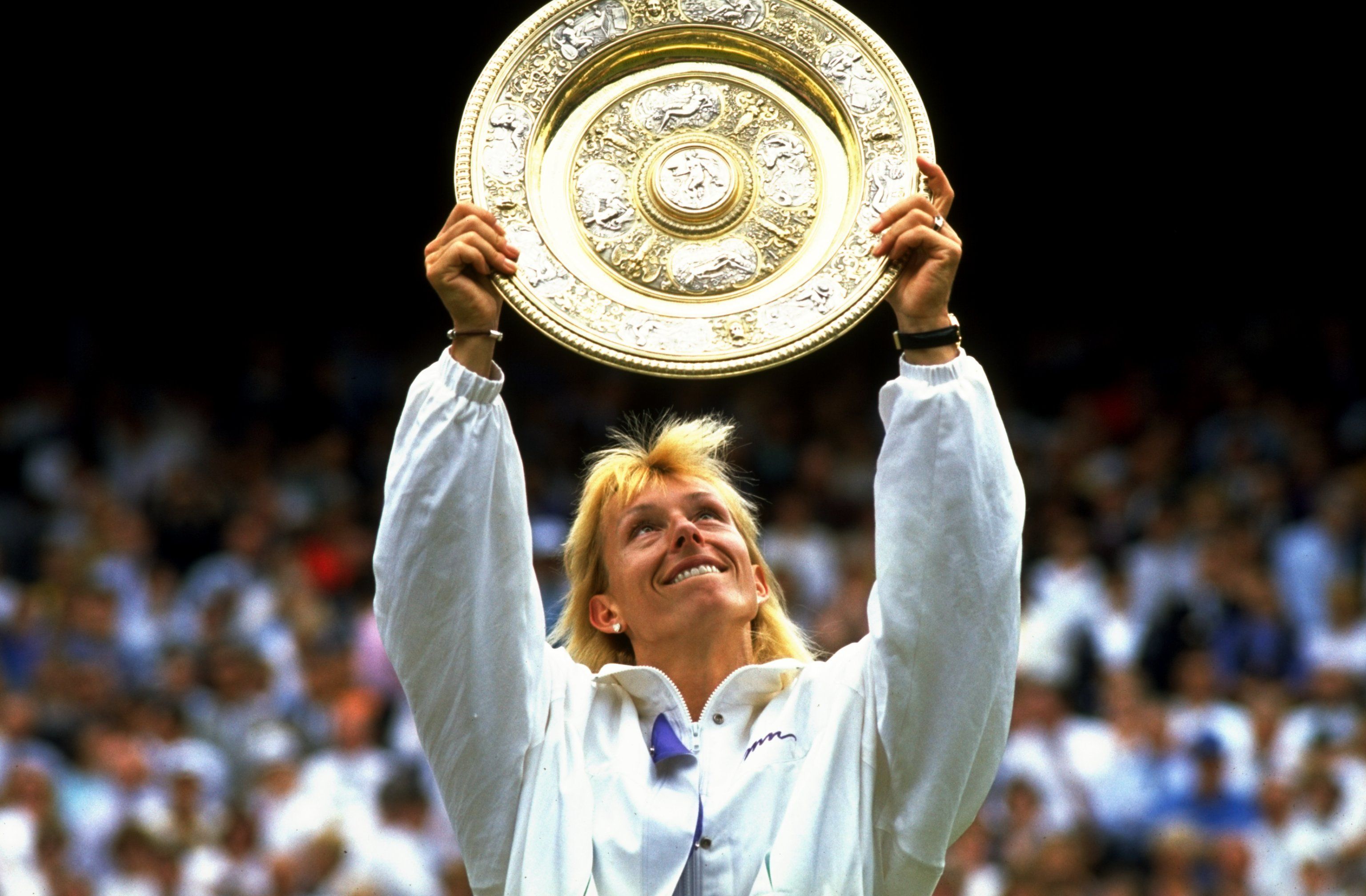 Martina Navratilova holds up Wimbledon trophy