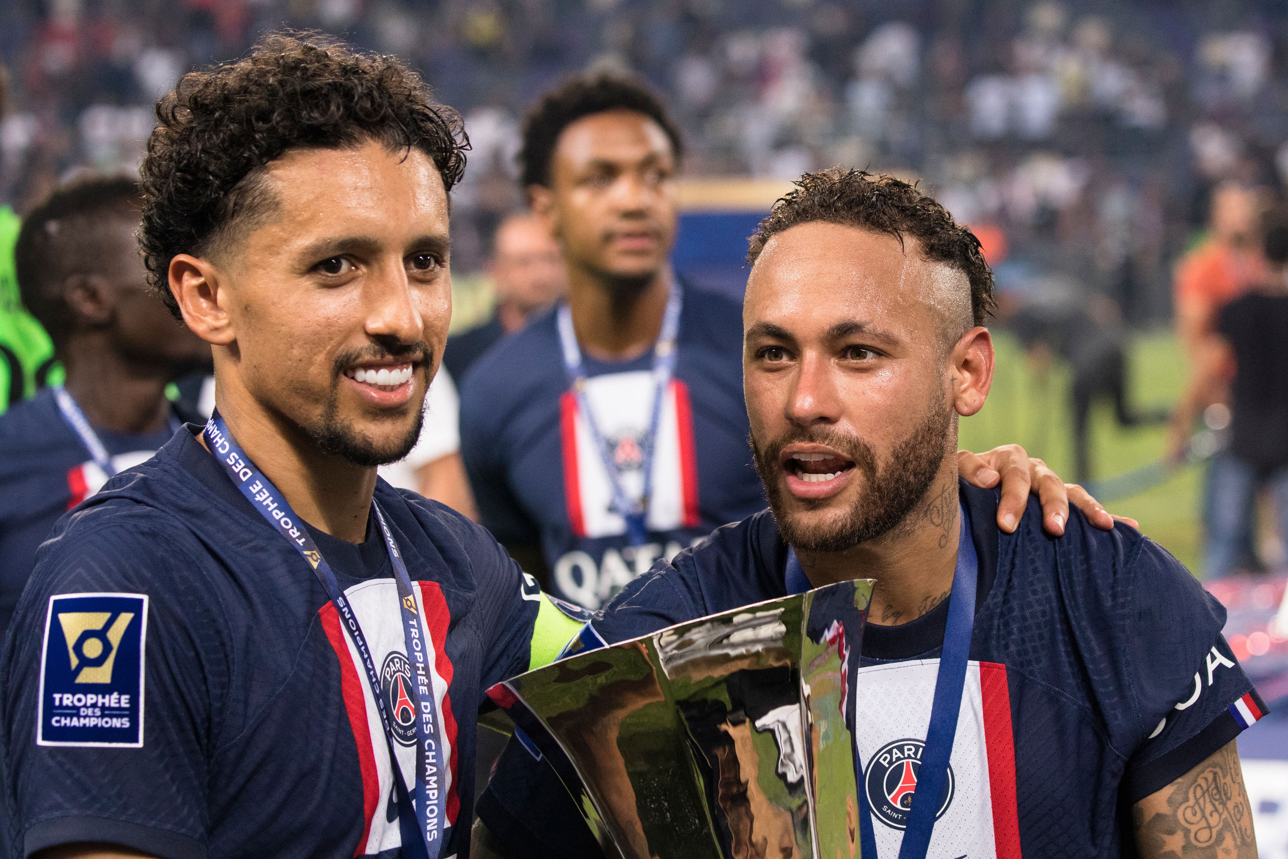 Paris Saint-Germain's Jr Neymar and Marquinhos celebrate with the trophy after winning the Champion's Trophy match