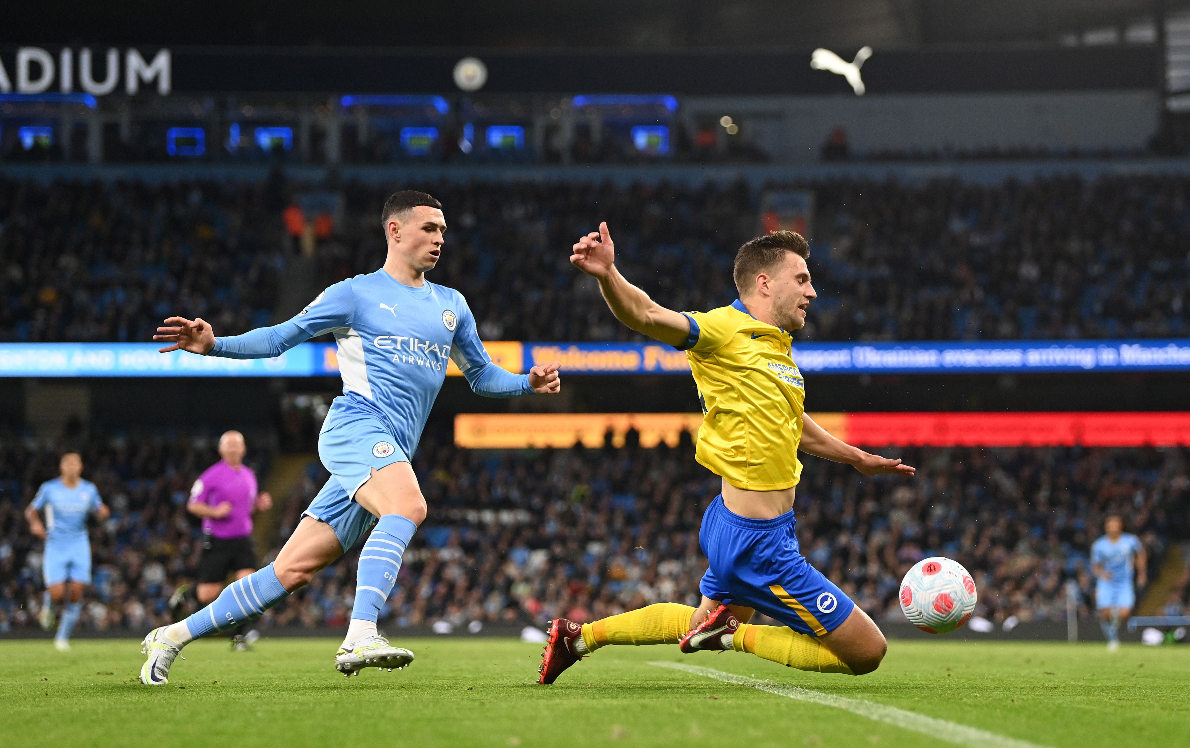 Joel Veltman of Brighton &amp; Hove Albion is tackled by Phil Foden of Manchester City