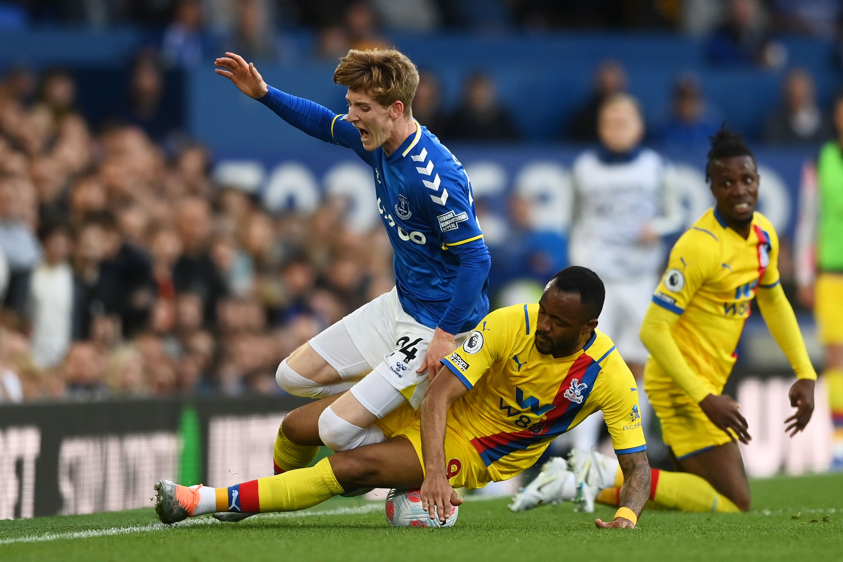 Anthony Gordon of Everton is tackled by Jordan Ayew of Crystal Palace