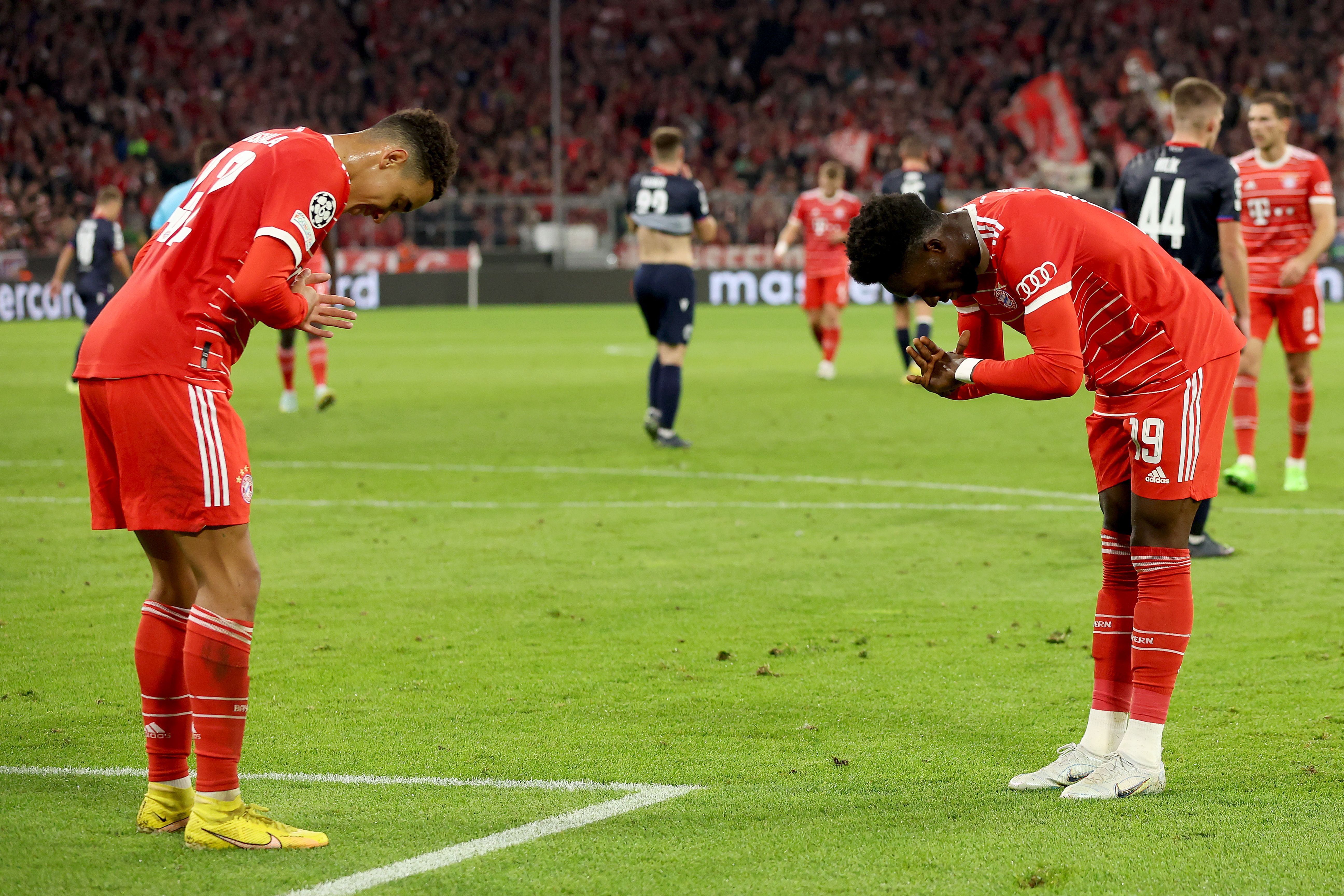 Jamal Musiala celebrates a goal with Alphonso Davies of Bayern Munich which was later disallowed by VAR during the UEFA Champions League group C match between FC Bayern München and Viktoria Plzen at Allianz Arena on October 04, 2022 in Munich, Germany