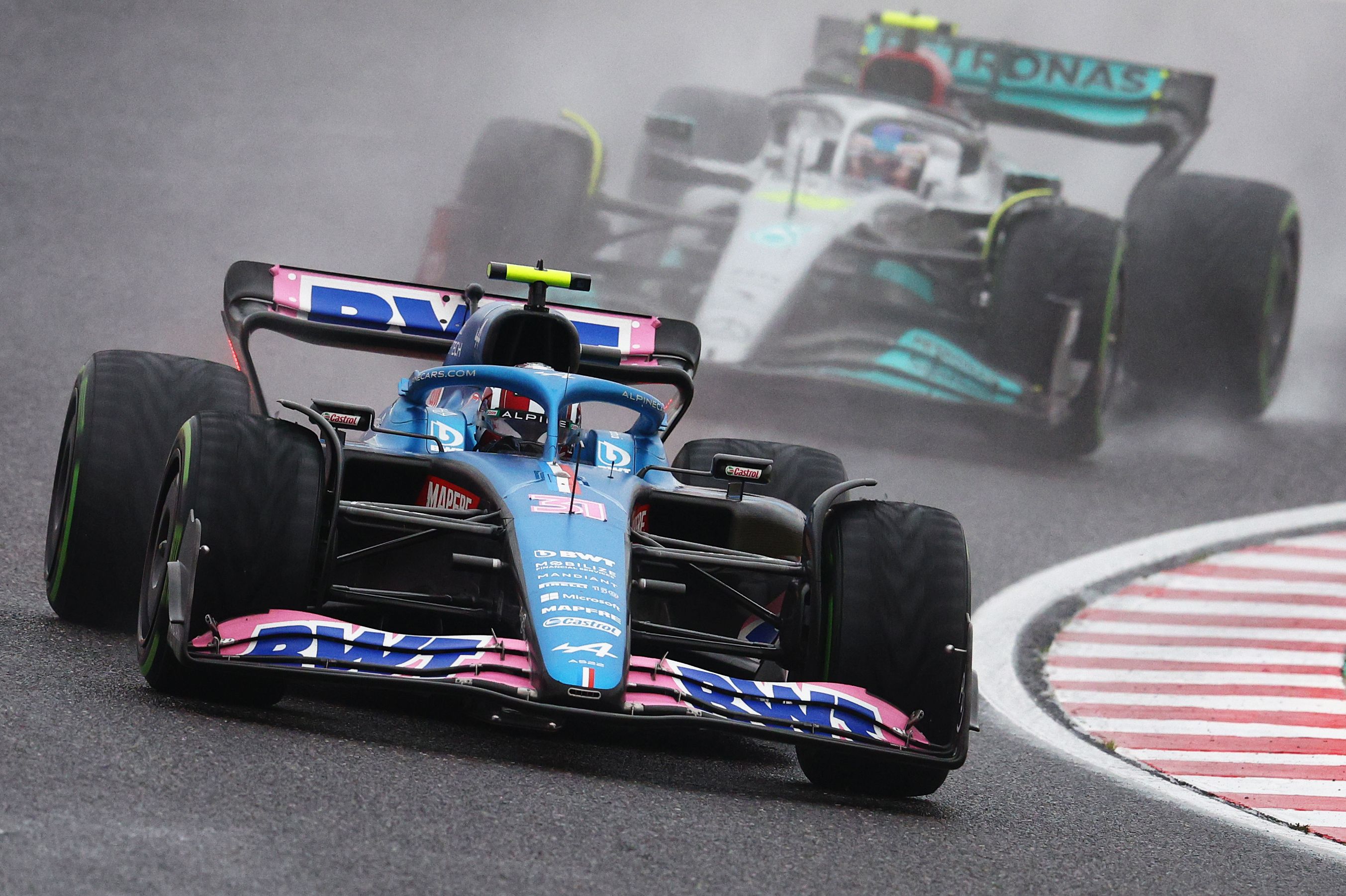 Esteban Ocon in front of Lewis Hamilton at Suzuka