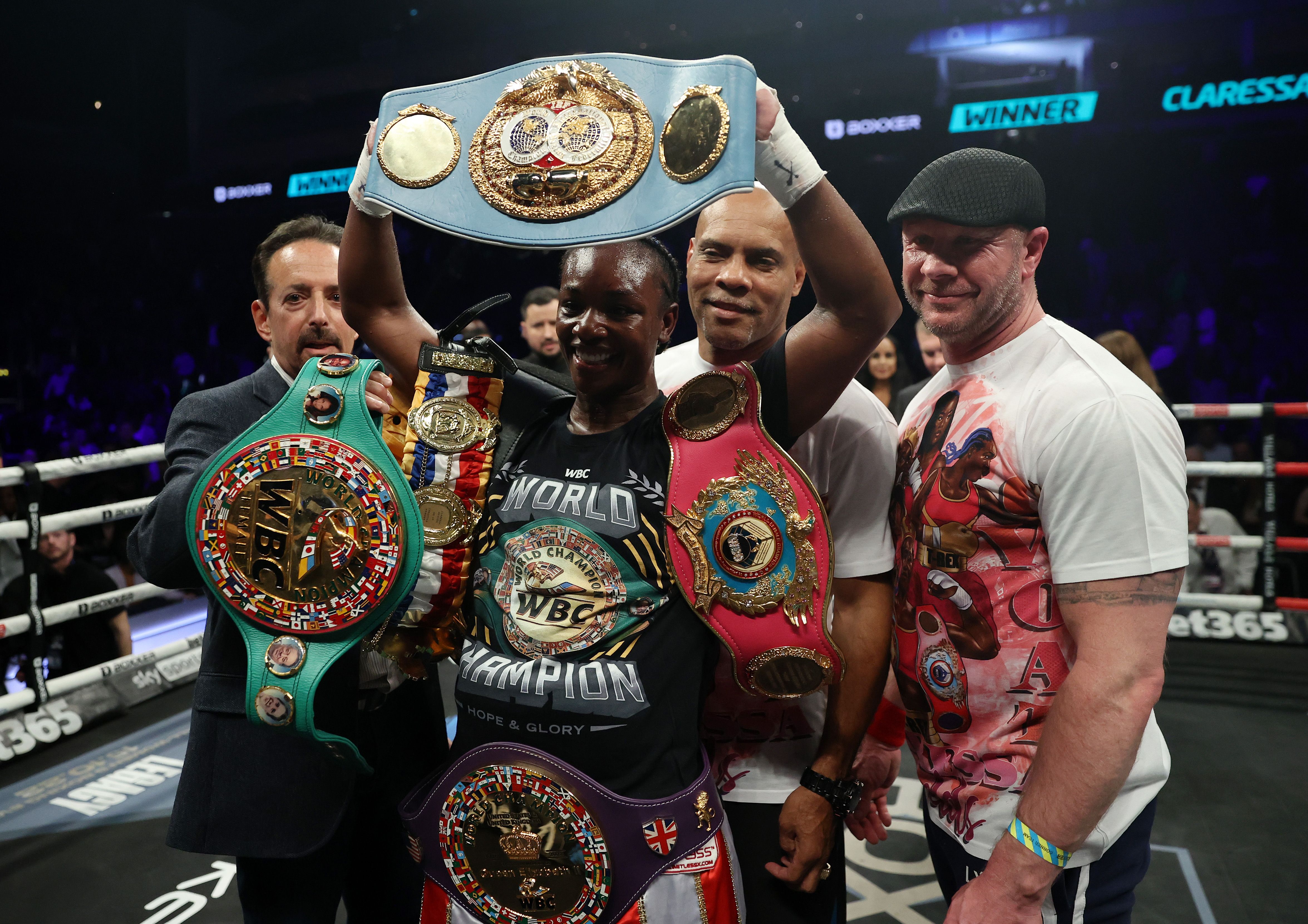 Claressa Shields poses with belts after win v Savannah Marshall