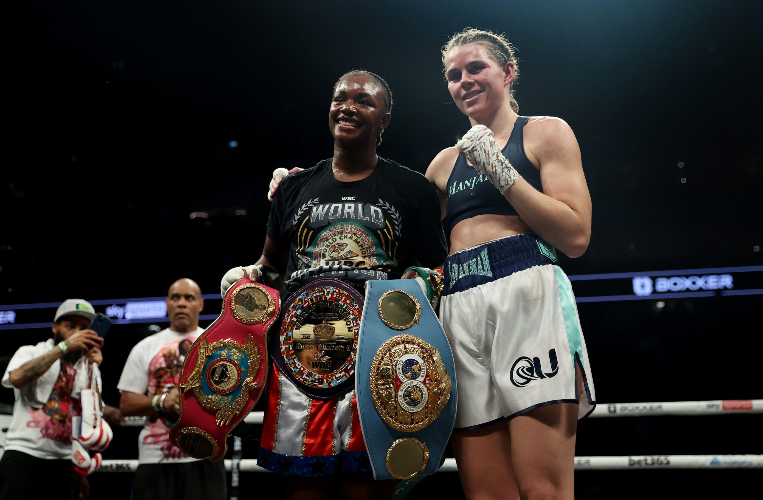 Claressa Shields poses with her belts alongside Savannah Marshall