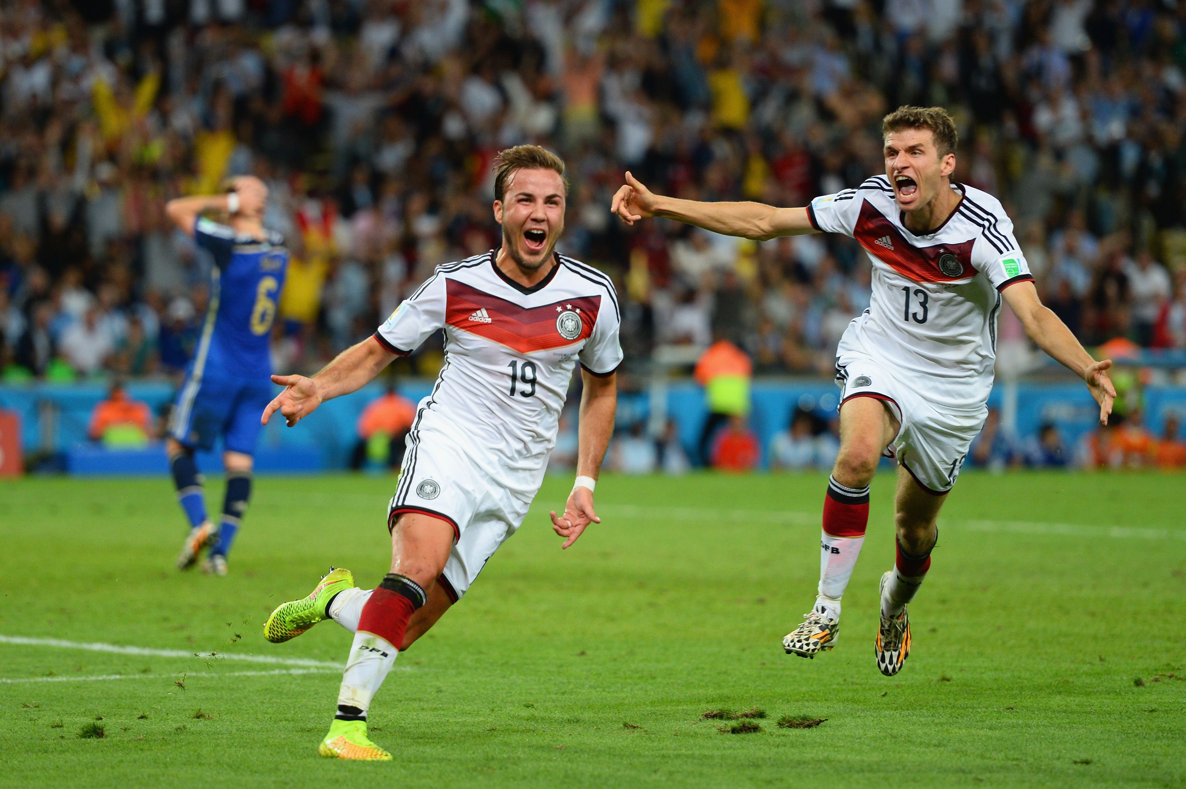Mario Gotze celebrates with Thomas Muller