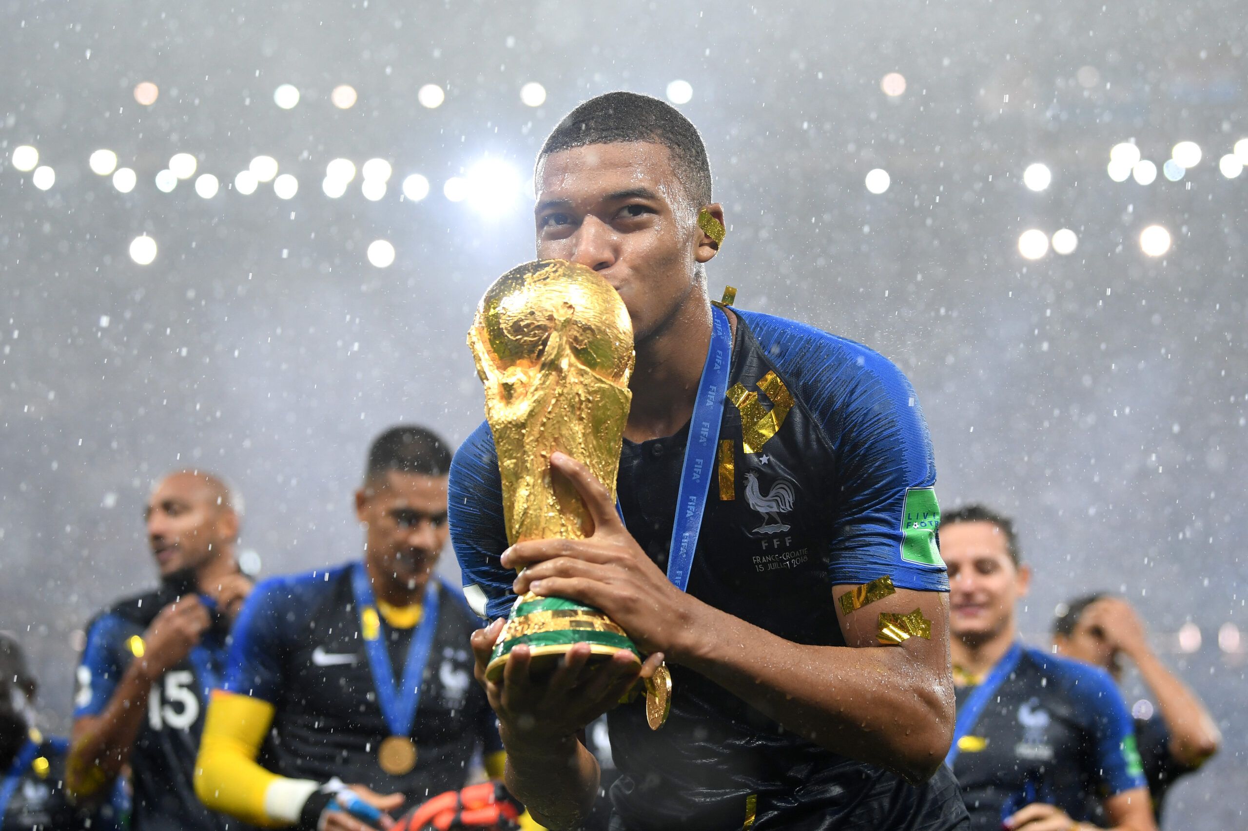 Kylian Mbappe kisses the World Cup trophy