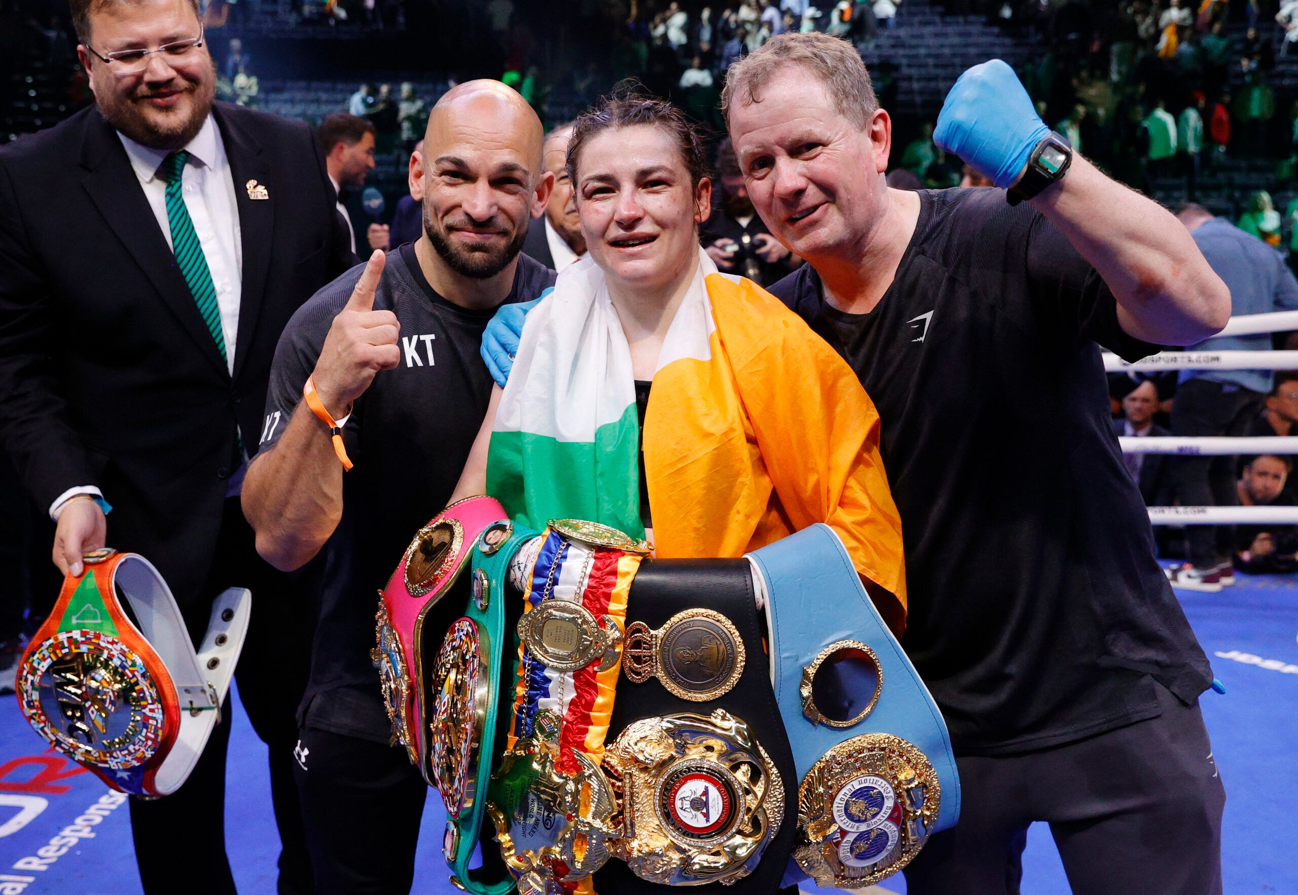 Katie Taylor celebrating with her boxing titles